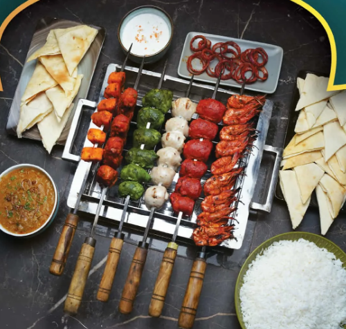 Kabab Giant platter of tandoori skewers with naan and rice at Kuisine